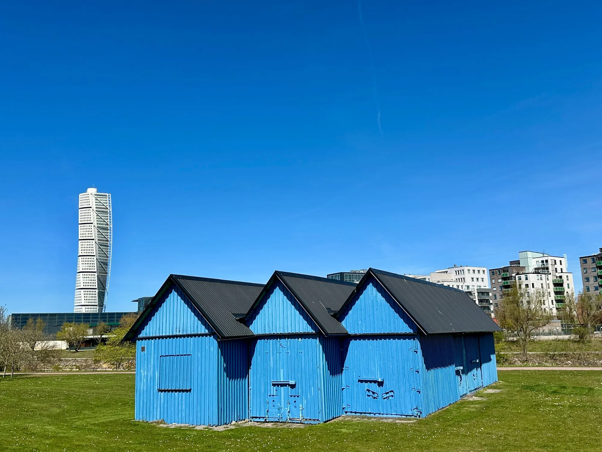 Blaue Badehäuschen auf der Wiese am Strand Ribersborg in Malmö.